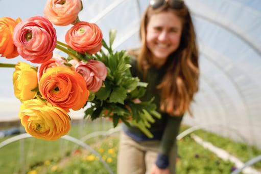 Greenhouse employee with flowers